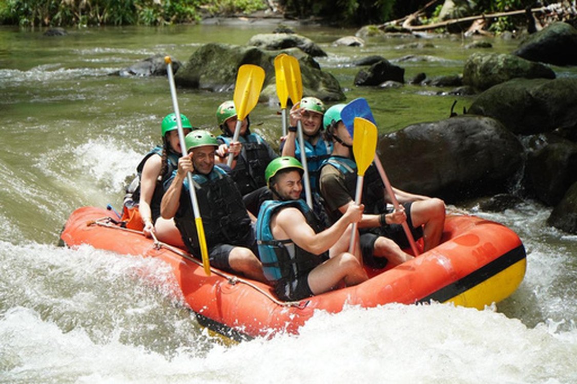 Rafting group paddling through rapids in Ubud