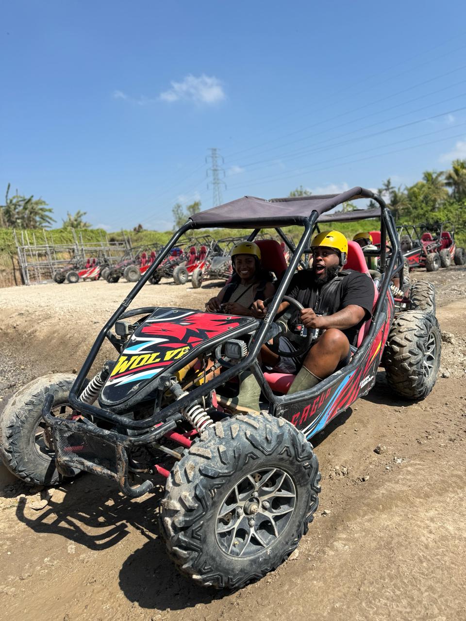 UTV buggy splashing through muddy countryside tracks in Ubud